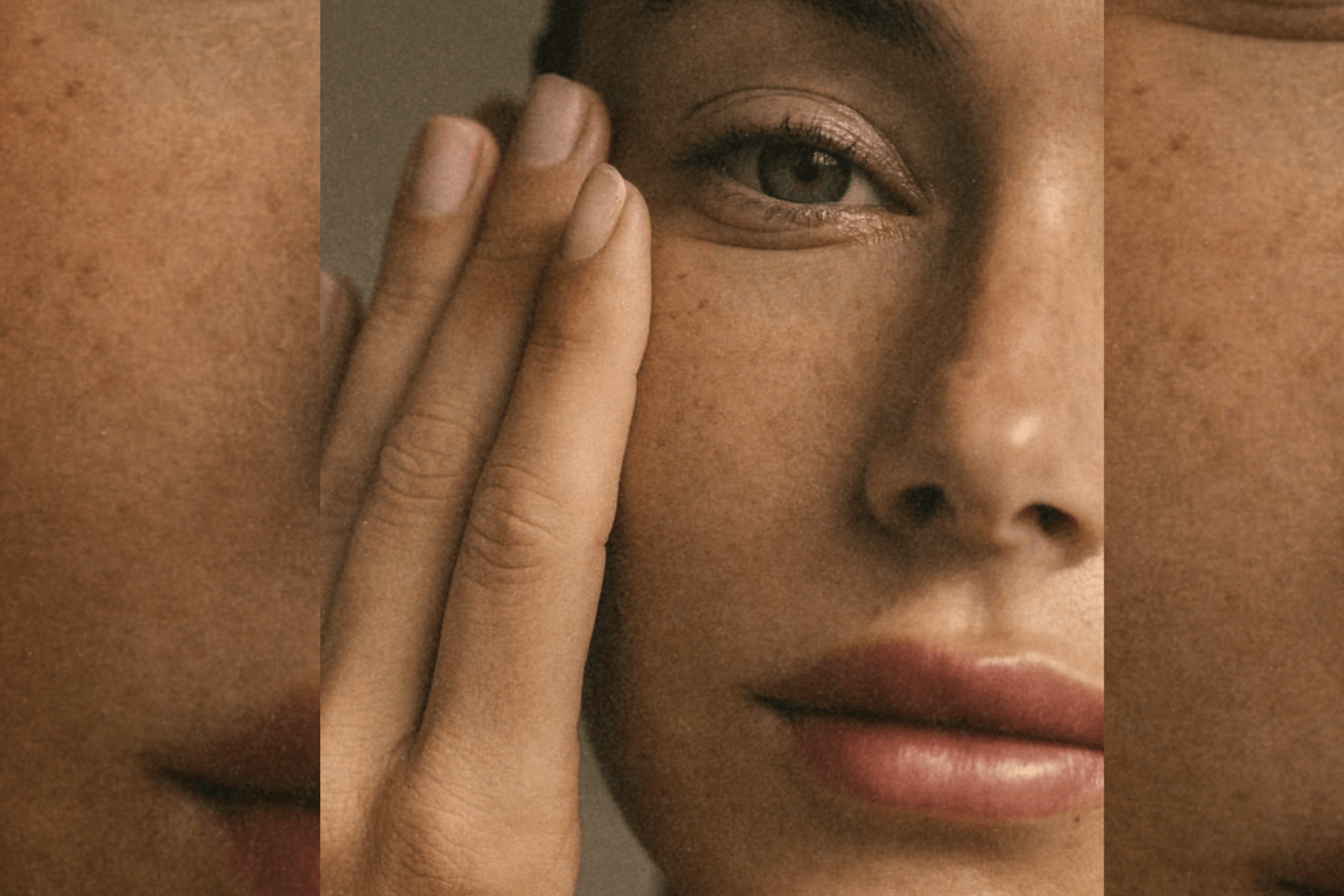 Portrait of a woman touching her cheek, framed by vertical panels that emphasize natural skin tone, freckles, and calm expression.