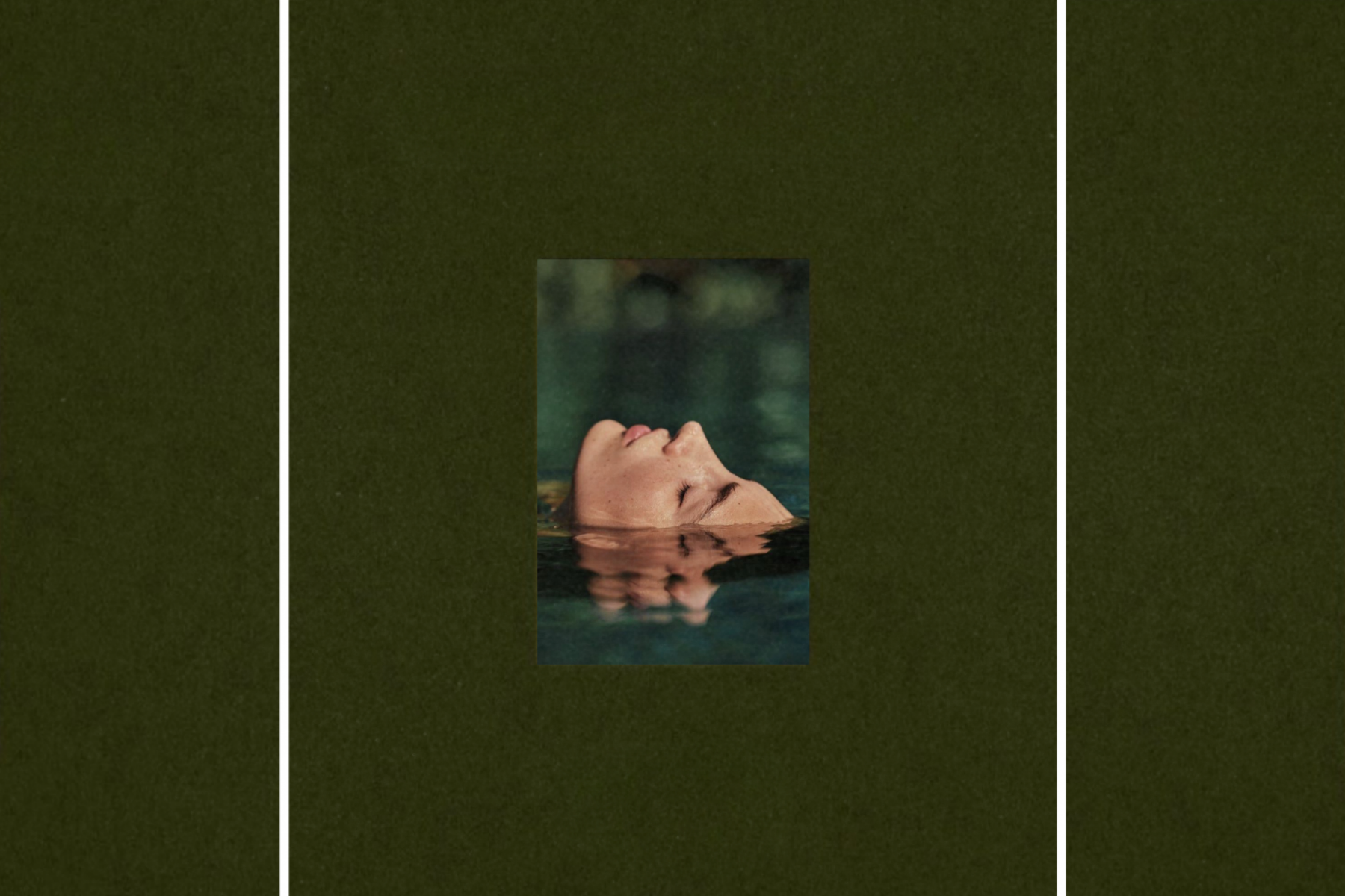 Centered portrait of a woman floating on her back in calm water, her face partially submerged and reflected, set against a deep green background with vertical panel framing.