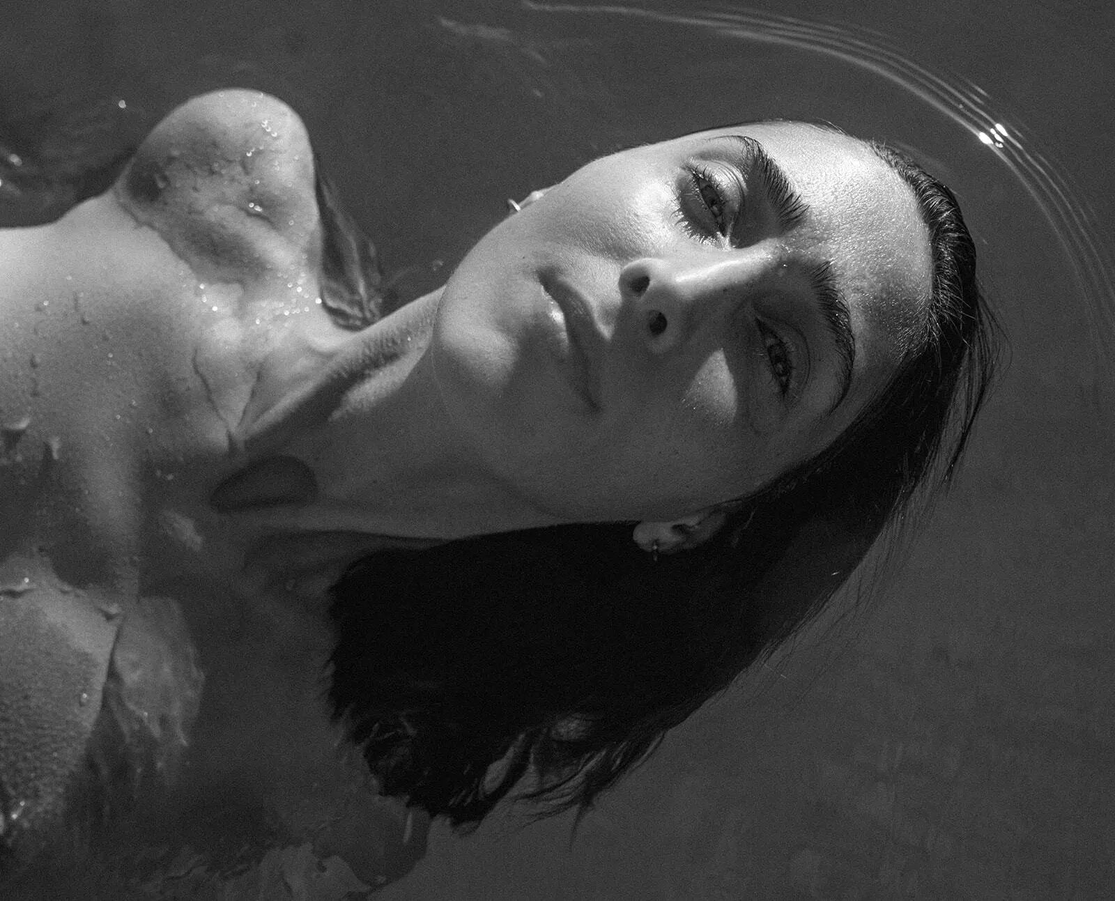 ATIKA Advanced Skin Nutrition hero image showing a woman floating in water with sunlight on her skin, representing calm, hydration, and renewal. Banner text reads “Foundational supplement for skin longevity,” describing an all-in-one daily drink with 18 clinically studied antioxidants, ceramides, collagen peptides, and cofactors supporting hydration, firmness, even tone, and UV/blue light defense.