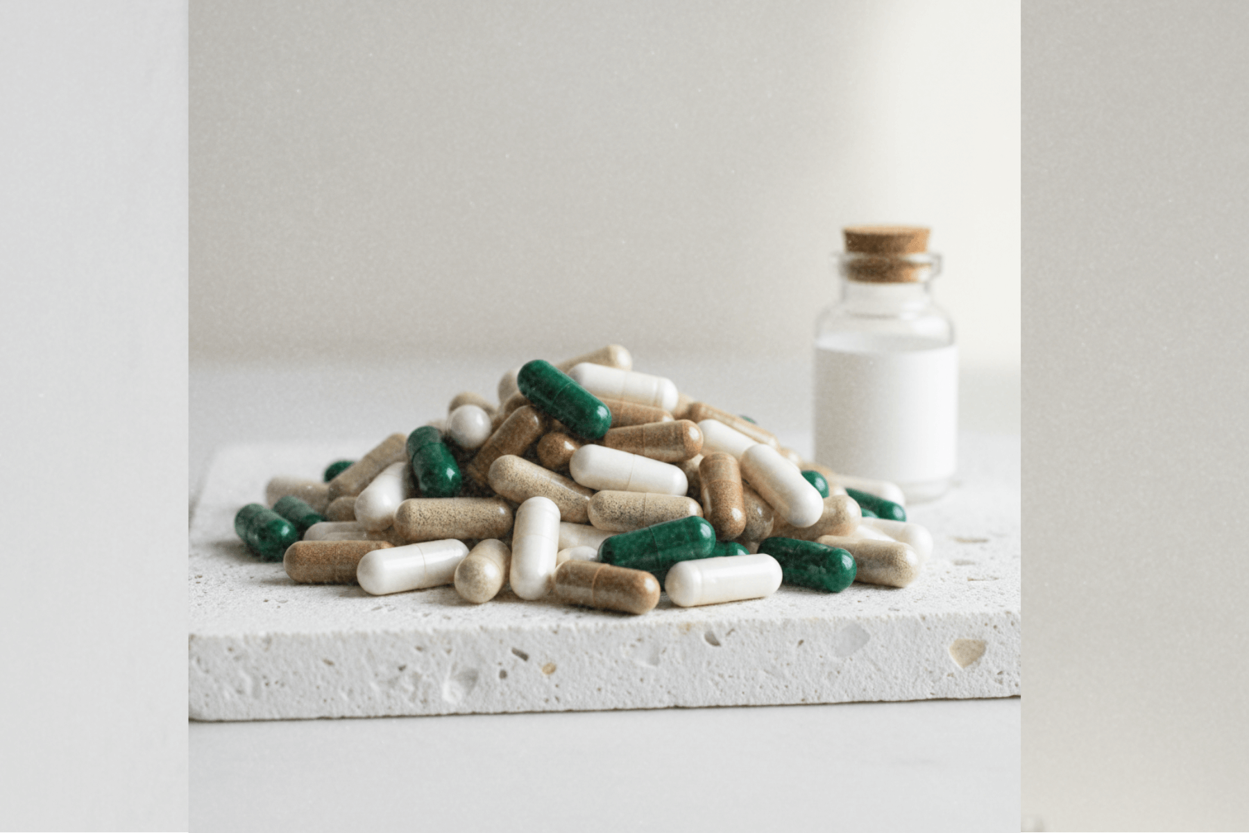 pile of capsules on white stone slab