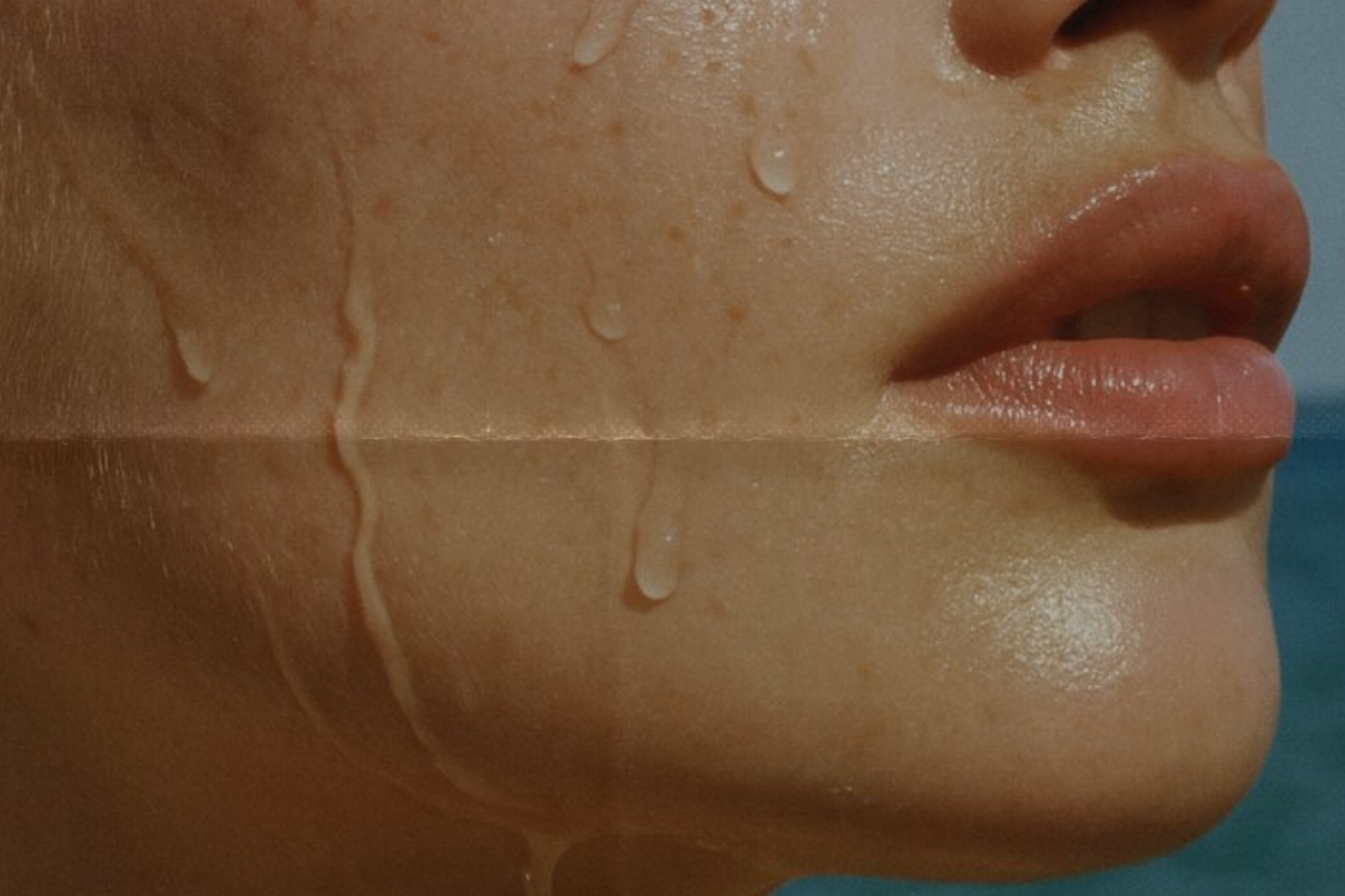 close up of female face with water dripping down the cheek