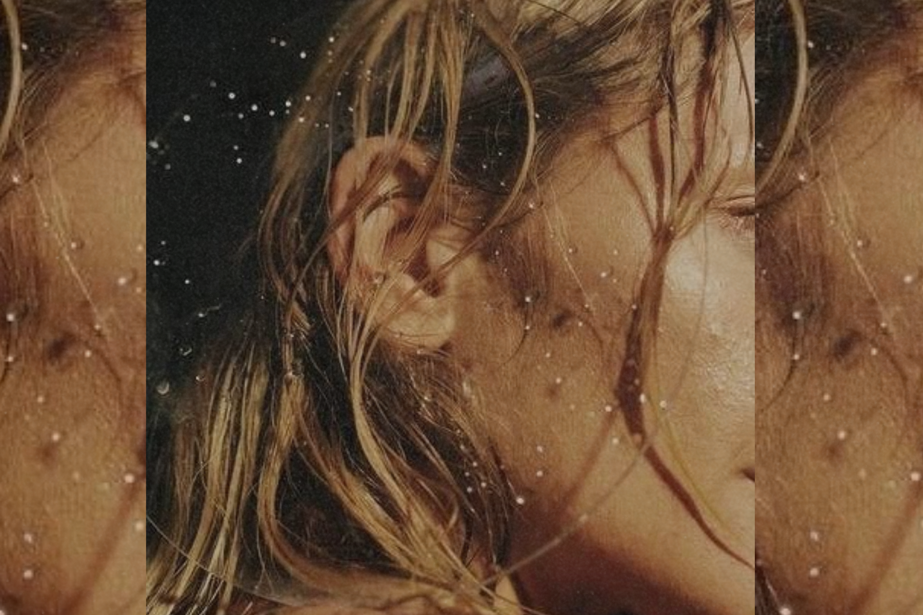 Close-up of a woman’s wet hair and skin with water droplets suspended in motion, textured light emphasizing moisture and natural detail.