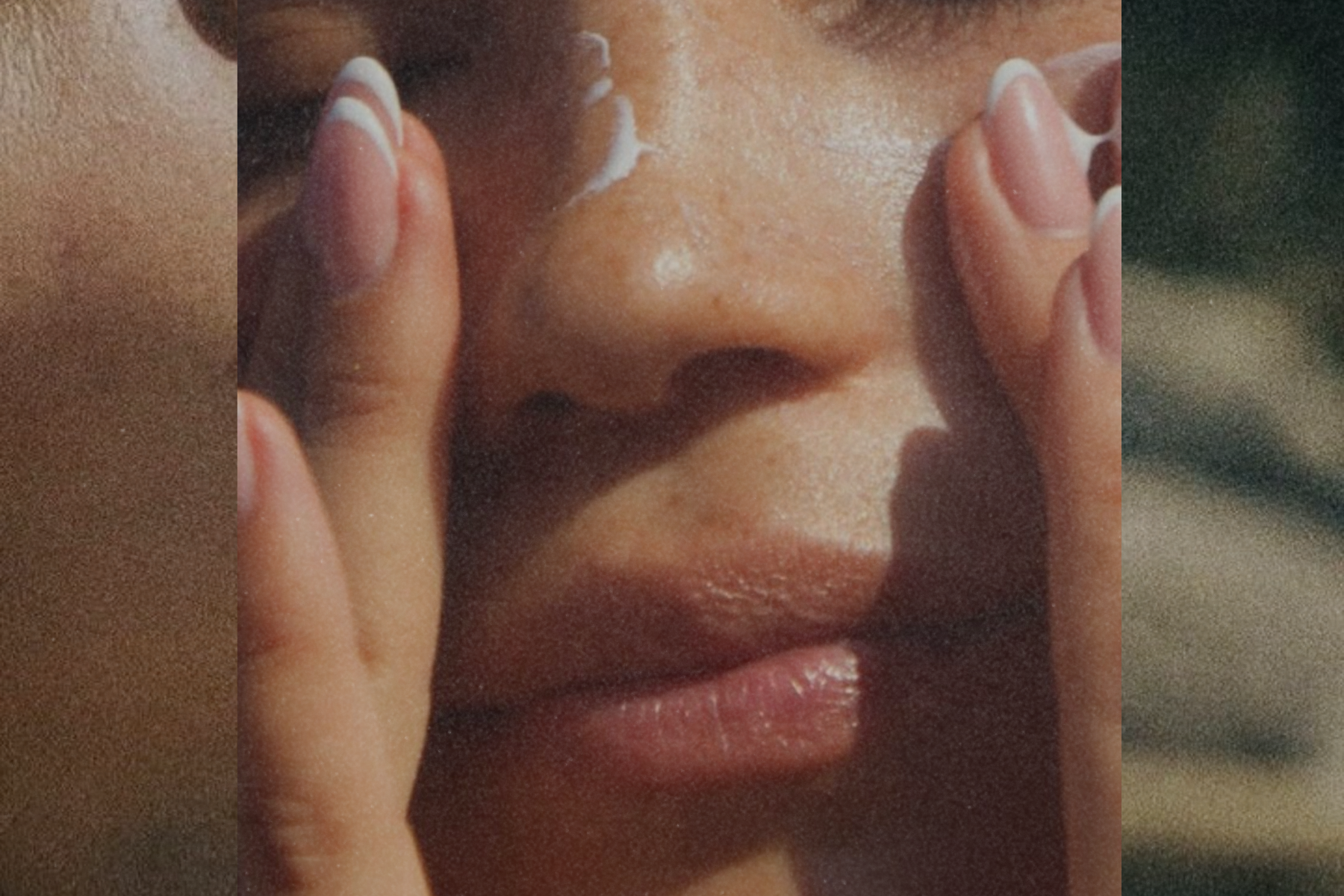 Close-up of a person applying a skincare cream to their face with both hands.